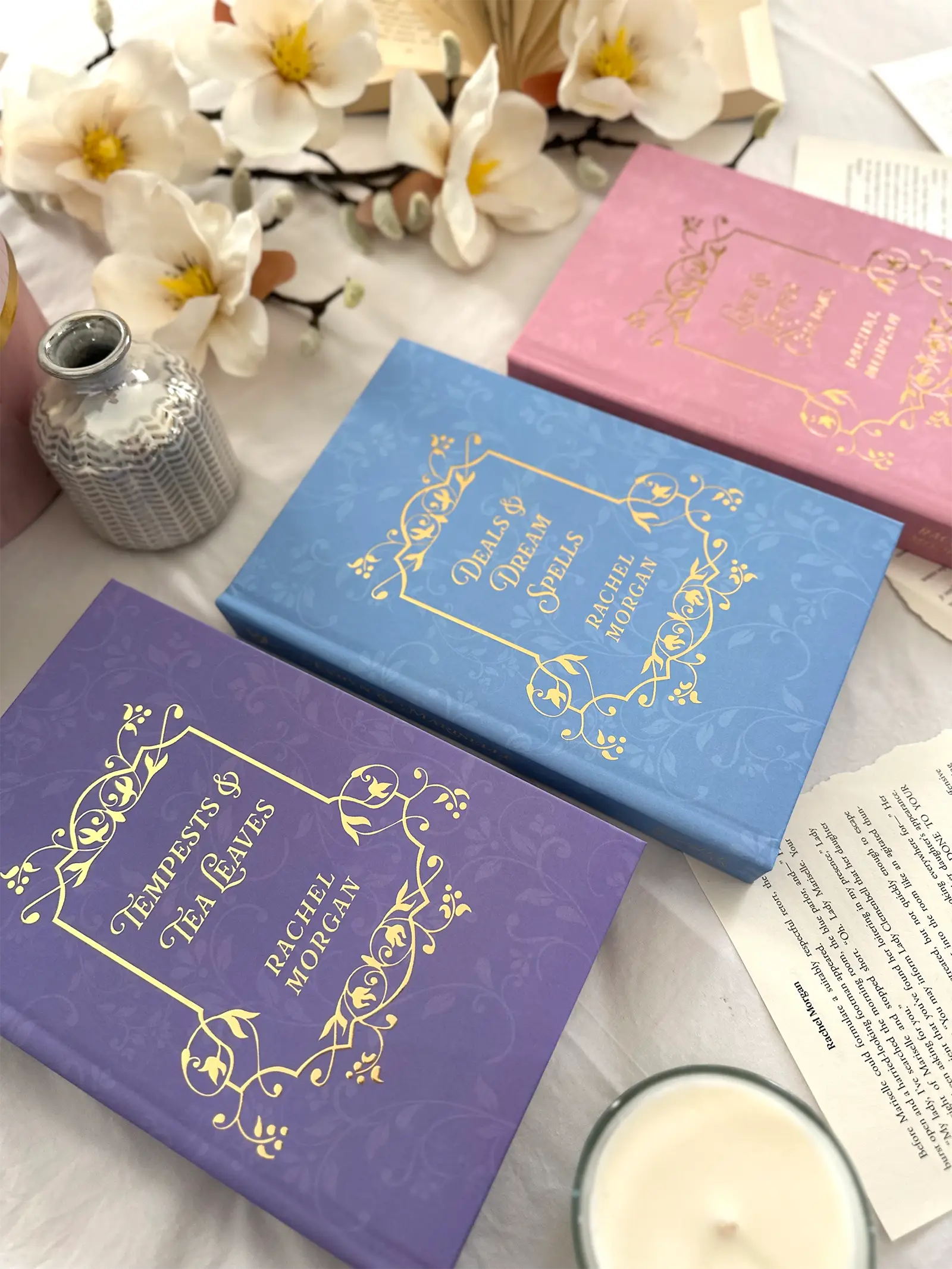 The gold foiled front covers of the Charmed Leaf Legacy special edition hardback books.