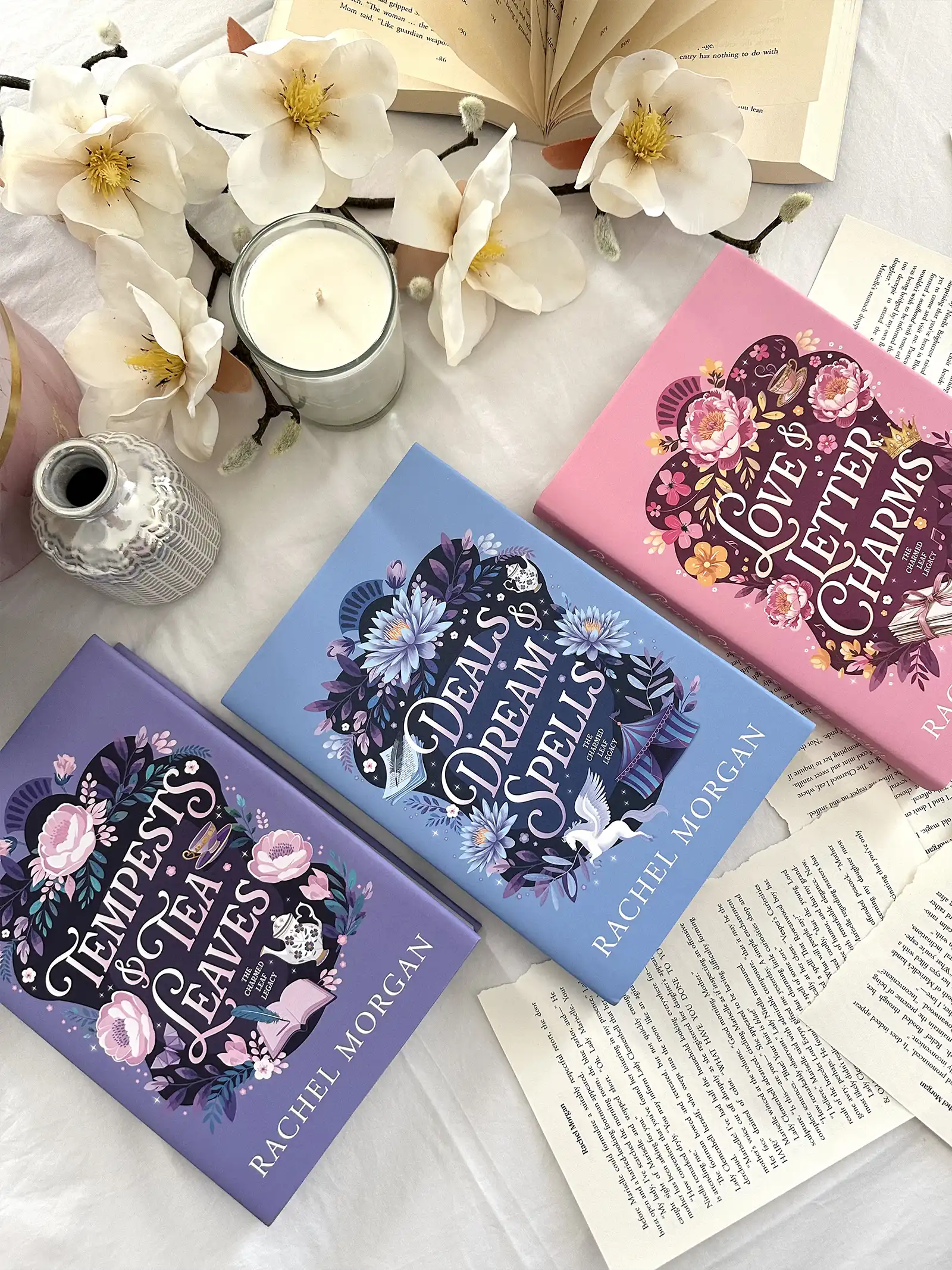 A styled flatlay of the Charmed Leaf Legacy special edition hardback books lying side by side.