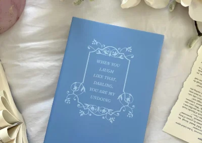 The back cover of the Deals & Dream Spells hardback special edition, showing a quote from the book within a decorative frame.