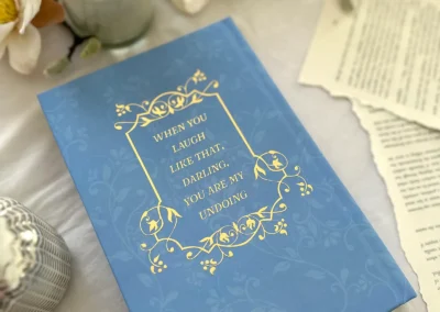A quote in gold foil on the back cover of the Deals & Dream Spells special edition, underneath the dust jacket.