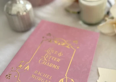 Close-up of the gold foil detailing on the front cover of the Love & Letter Charms special edition, underneath the dust jacket.